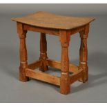 A ROBERT THOMPSON 'MOUSEMAN' OAK STOOL, with dished adzed top of rectangular form,