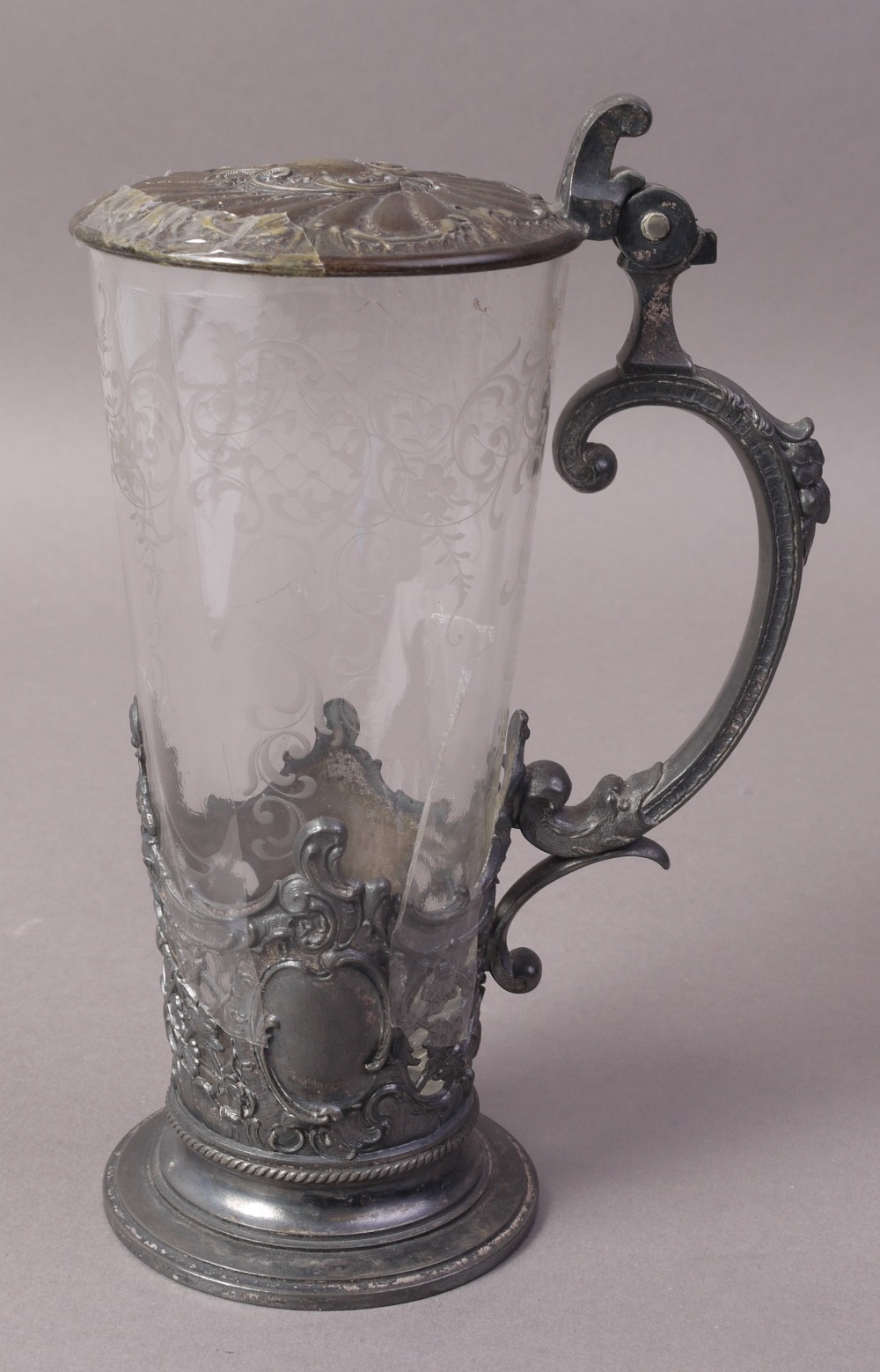 A WMF SILVER PLATED AND ETCHED GLASS LIDDED TANKARD, cast with fruiting vine, trellis and cartouche,