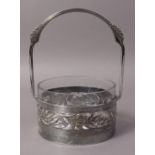 A WMF CIRCULAR PRESERVE BASKET with clear glass liner, pierced laurel leaf,