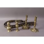 AN 18TH CENTURY BRASS EJECTOR CANDLESTICK of plain cylindrical form on petal shaped foot, 16.