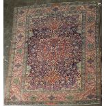 A PERSIAN WOOL RUG, worked with a central middle ground,