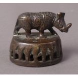 A 19TH CENTURY BRONZE FIGURE OF A RHINOCEROS, standing,