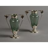 A PAIR OF ART NOUVEAU IRIDESCENT GREEN GLASS AND SILVER MOUNTED TWO HANDLED VASES,