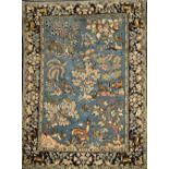 A 20TH CENTURY PERSIAN WOOL PICTORIAL RUG, worked with deer, stag,