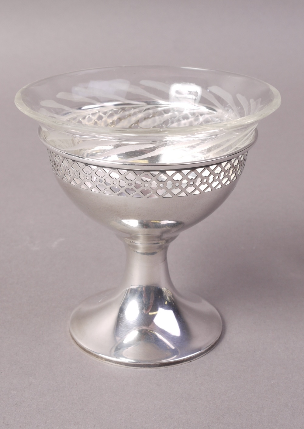 A SILVER PEDESTAL DISH with pierced border to rim and with glass liner, 8.