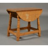 A LIGHT OAK DROP LEAF OCCASIONAL TABLE IN MOUSEMAN STYLE,