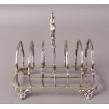 A VICTORIAN SILVER TOASTRACK of seven bars, London 1888, with shell and scroll loop handle,