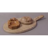 A ROBERT THOMPSON 'MOUSEMAN' OAK CHEESEBOARD, of oval form with mouse motif carved to the handle,