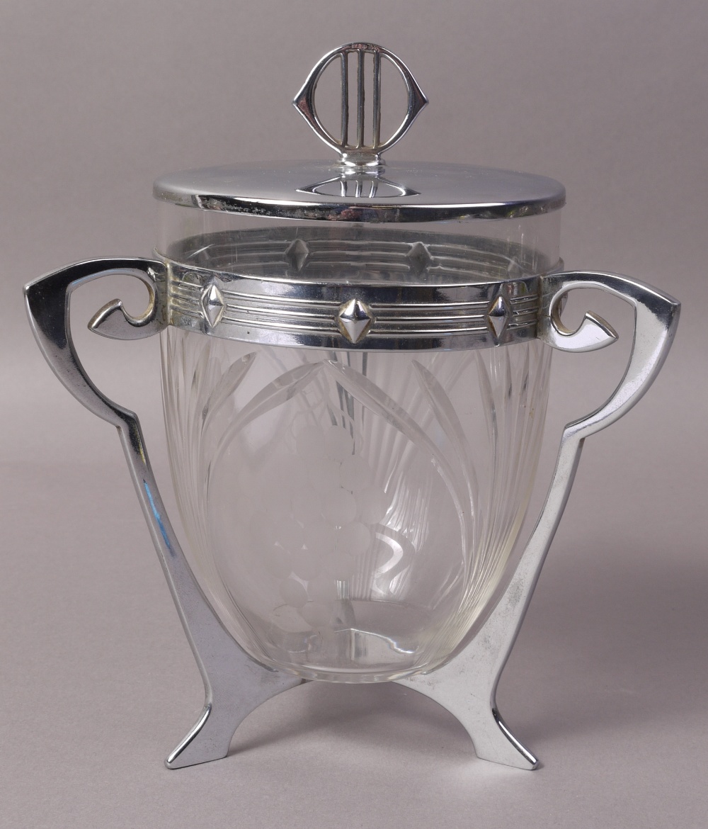 A WMF BISCUIT BARREL AND COVER with clear glass 'U' shaped liner,