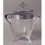 A WMF BISCUIT BARREL AND COVER with clear glass 'U' shaped liner,