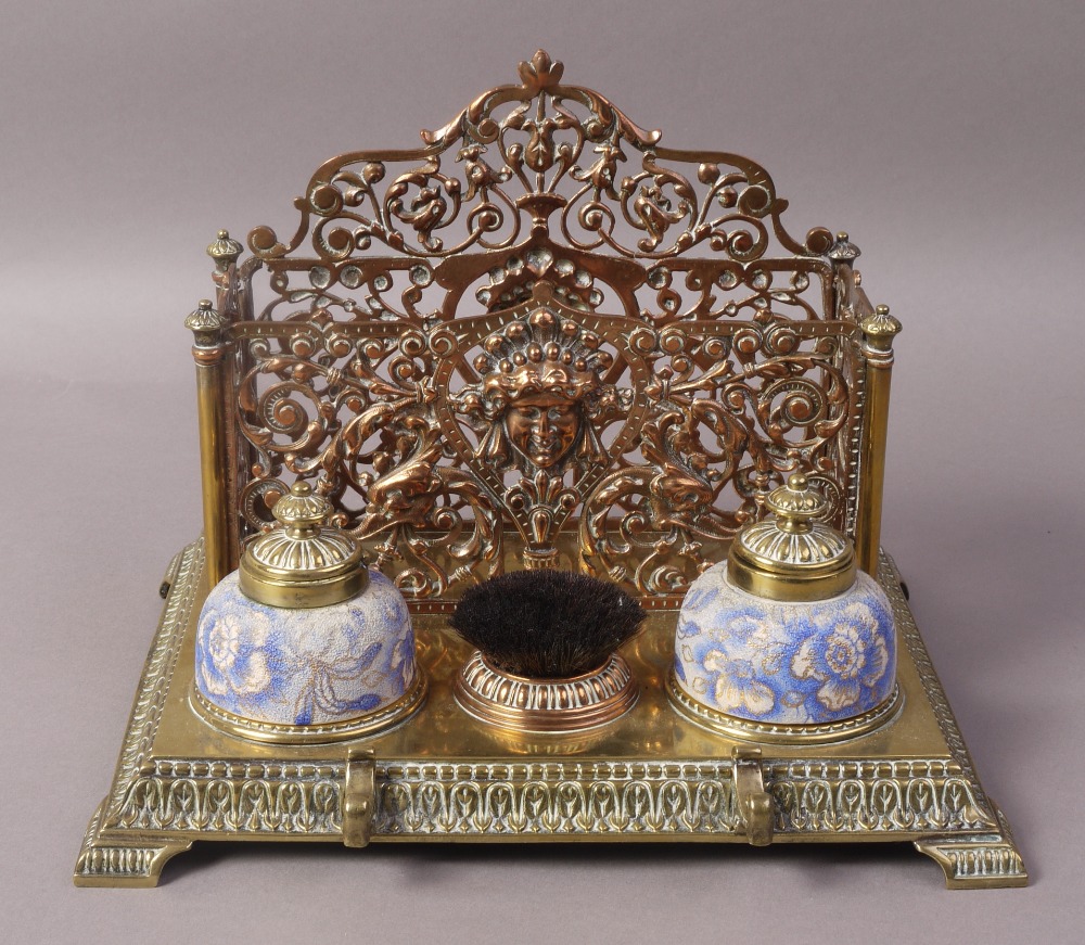 A MID VICTORIAN BRASS AND COPPER STANDISH, with scroll cast letter rack,