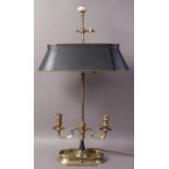 A FRENCH STYLE BRASS TABLE LAMP with central stem fitted with oval metal shade flanked by twin