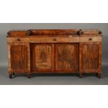 A LATE REGENCY ROSEWOOD INVERTED BREAKFRONT SIDEBOARD with low raised back flanked by raised