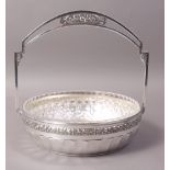 A SECESSIONIST STYLE SILVER PLATED BASKET, the fixed handle pierced and cast with panel of fruit,