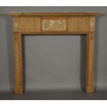 A PINE ADAM STYLE FIRE SURROUND, with a central moulded classical rectangular frieze,