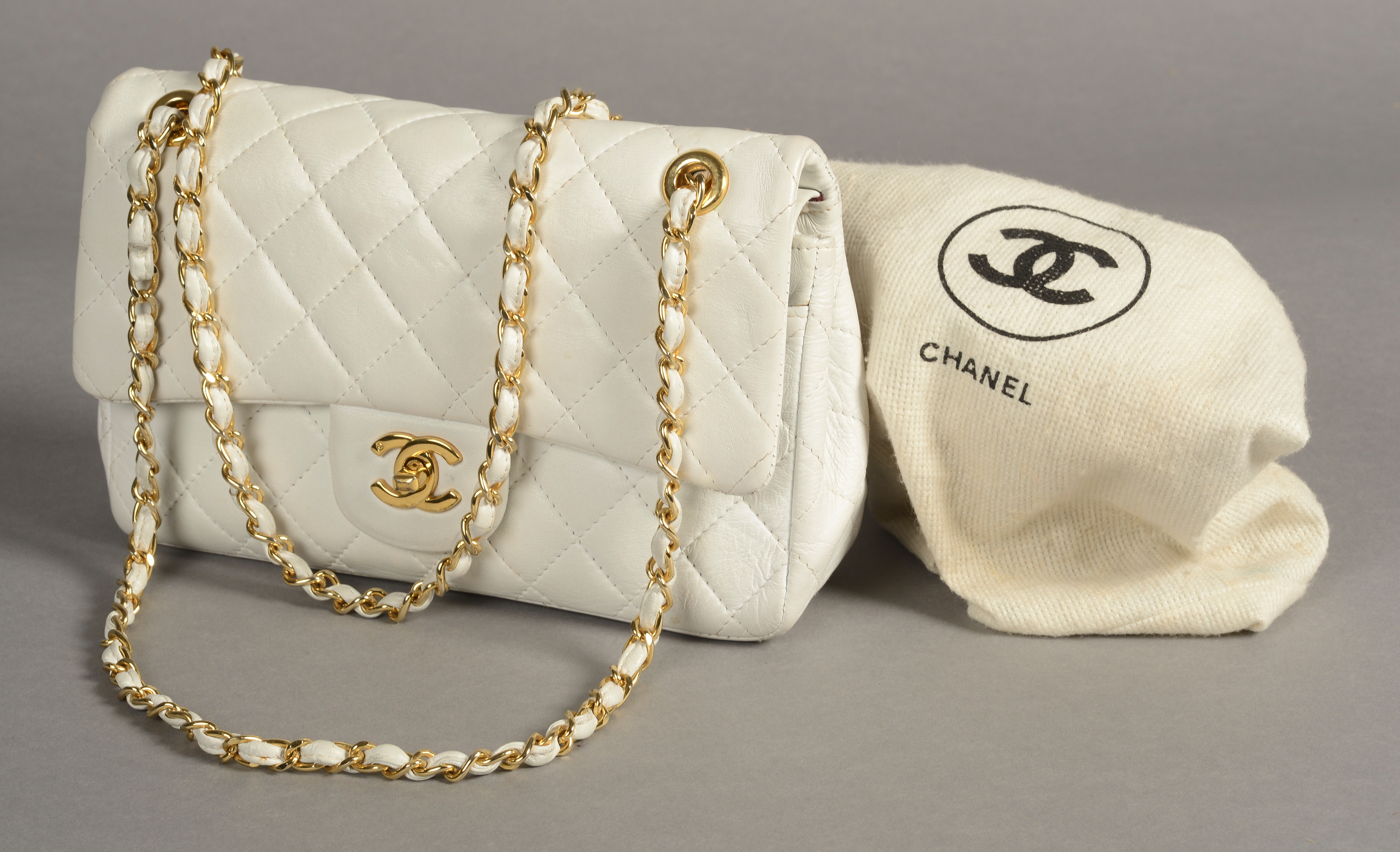 A VINTAGE CHANEL MAXI FLAP BAG, quilted white lambskin,