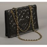 A VINTAGE CHANEL BAG, quilted navy lambskin, gilt metal chain and lambskin entwined strap,