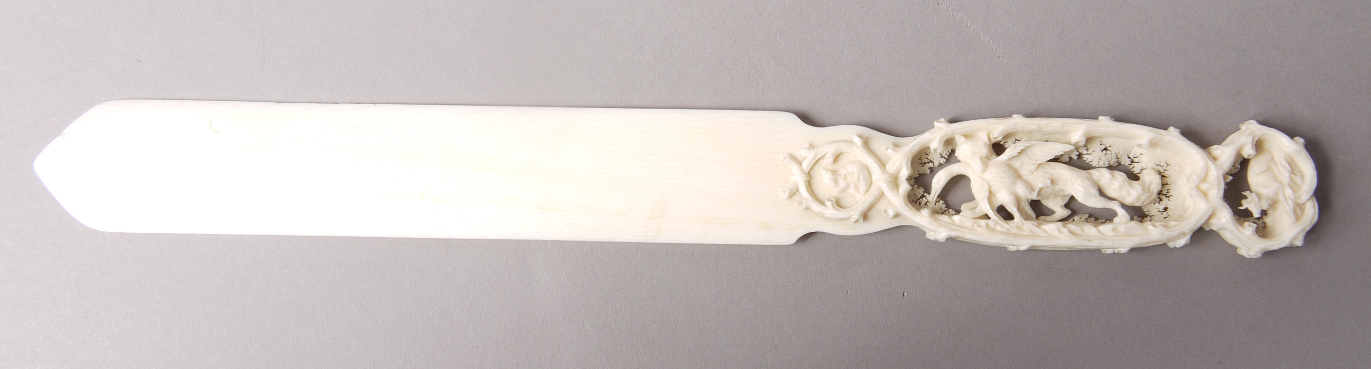 AN AUSTRIAN CARVED IVORY PAGE TURNER, c.