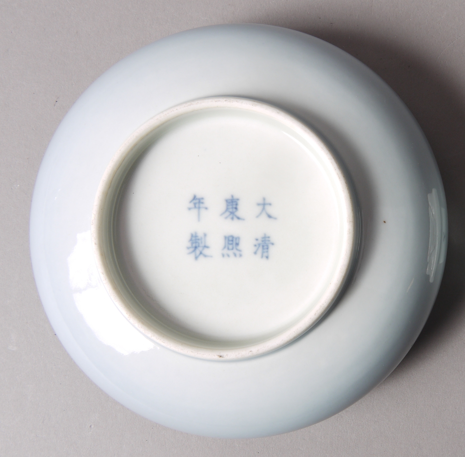 A CHINESE PORCELAIN SHALLOW BOWL with everted rim, pale blue graduated glaze, - Image 2 of 2