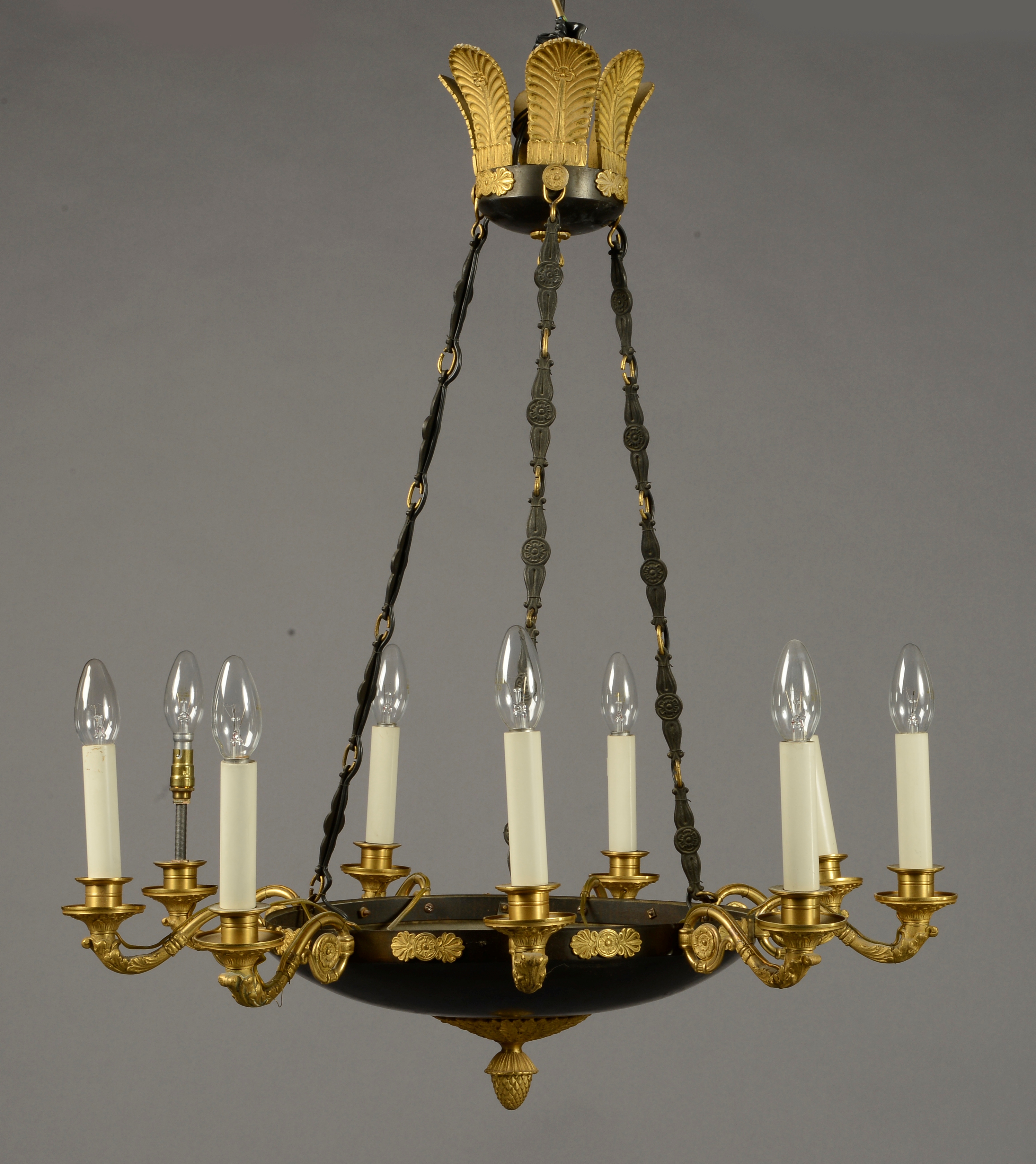 AN EMPIRE STYLE NINE BRANCH CHANDELIER, with gilt scroll arms from a circular dish,