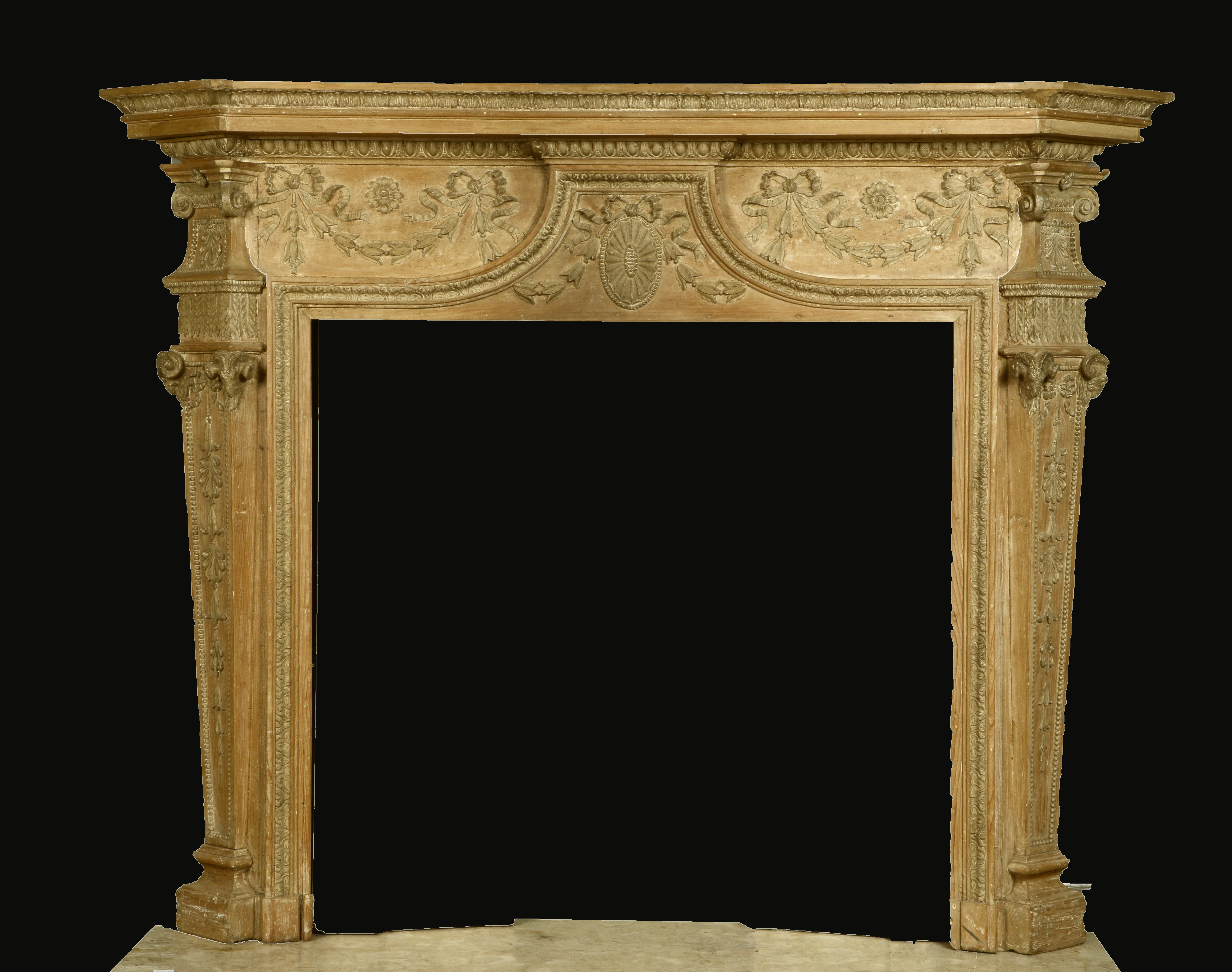 A PINE ADAM STYLE FIRE SURROUND with applied and carved decoration with central oval paterae and