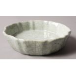 A CHINESE GREEN CELADON CRACKLE GLAZED SMALL DISH with wavy shaped rim,