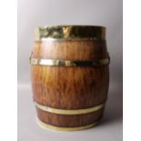 A STAVED OAK AND BRASS BARREL SHAPED STICK STAND, of oval outline,