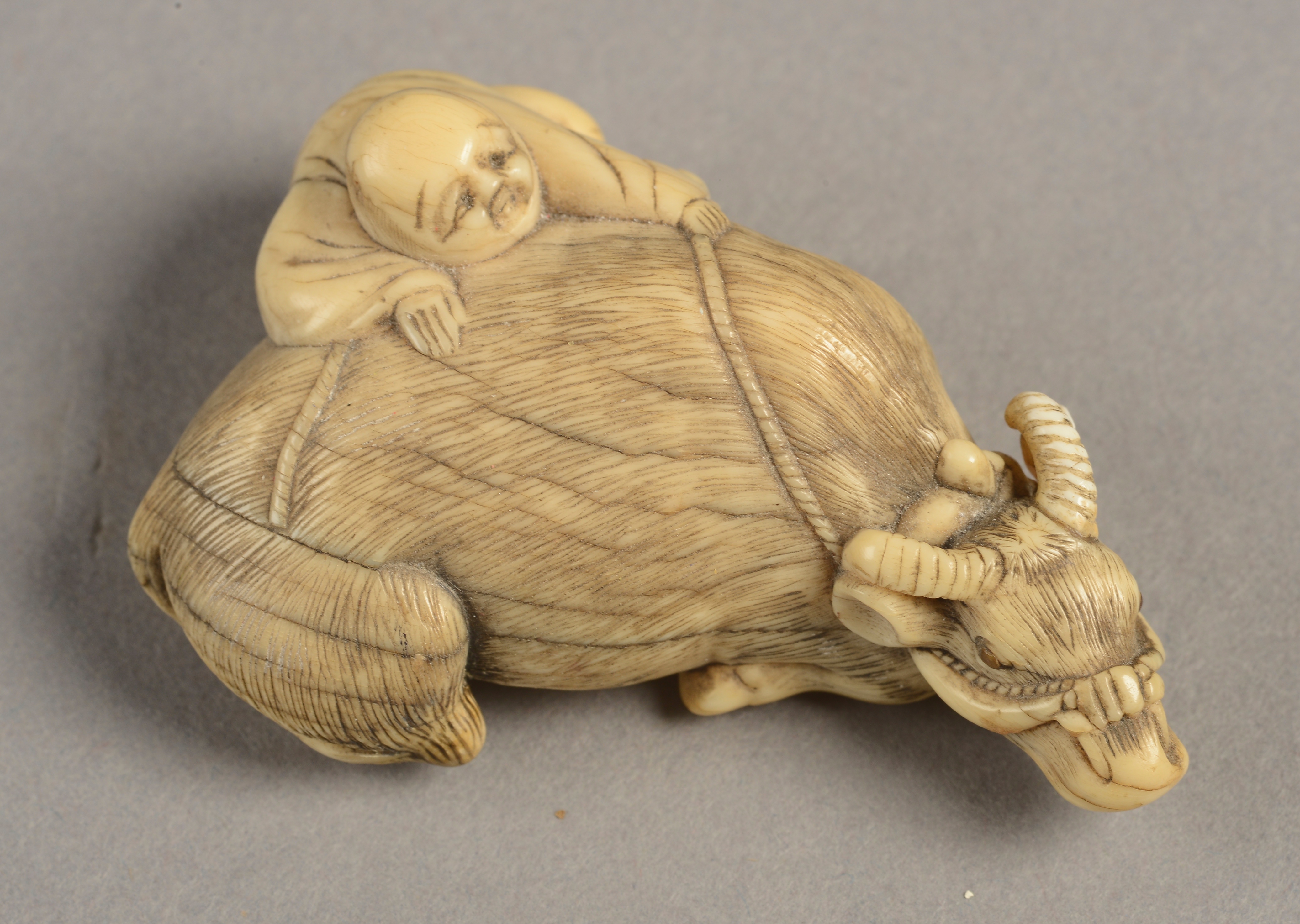 A JAPANESE IVORY NETSUKE in the manner of Tomotada, Meiji period,