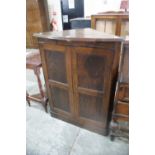 An Oak Two Door Standing Corner Cupboard