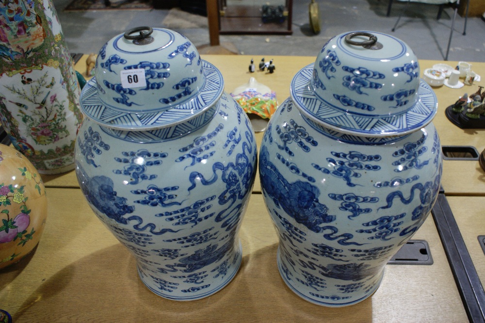 An Impressive Pair Of Large Circular Based Blue And White Oriental Vases And Covers With Ring Handle