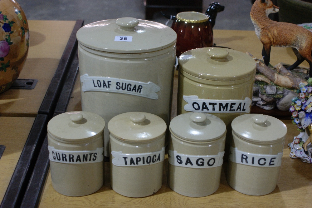 A Set Of Six Stoneware Kitchen Storage Jars Including Loaf Sugar And Oatmeal