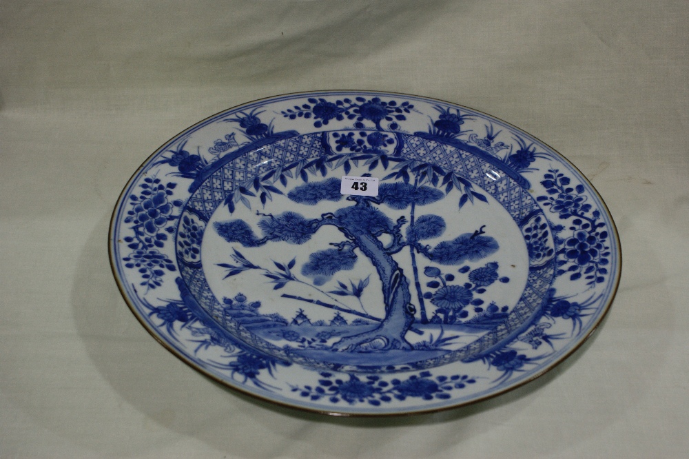 An Early 19th Century Chinese Blue And White Circular Charger With Centre Panel Of Bamboo And Fir