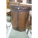 An Antique Oak Bow Front Two Door Hanging Corner Cupboard