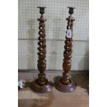 A Pair Of Tall Circular Based Wooden Barley Twist Candle Holders