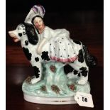 A Staffordshire Pottery Model Of Child Riding A Black And White Spaniel