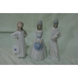 A Lladro Porcelain Figure Of A Child Together With Two Other Similar Groups