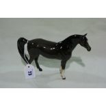 A Brown Glazed Beswick Swish Tail Horse