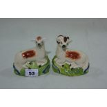 A Pair Of Staffordshire Pottery Seated Ram And Ewe Ornaments