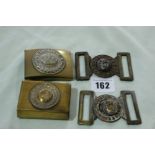A German First World War Brass Belt Buckle And Matchbox Holder Together With Two Other Brass Belt