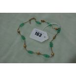 A 14 Carat Gold And Emerald Bead Necklace