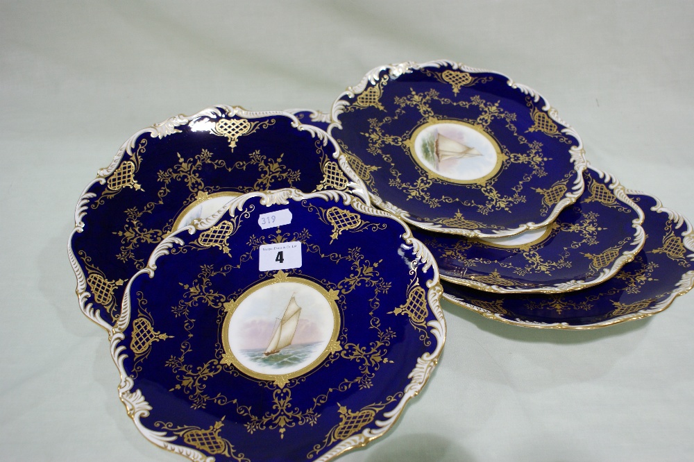 A Set Of Six Coalport Deep Blue And Gilt Ground Dessert Plates Each With Centre Painted Sailboat