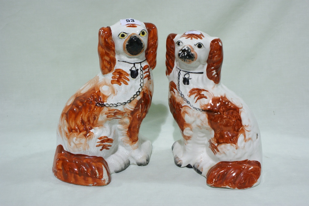 A Pair Of Staffordshire Pottery Red And White Seated Dogs