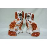 A Pair Of Staffordshire Pottery Red And White Seated Dogs