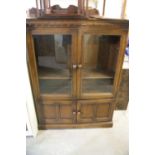 A Polished Oak Two Door Glazed Bookcase Cabinet