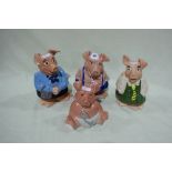 A Group Of Four Wade Pottery Nat-West Piggy Banks