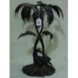An Elkington & Co Plated Centre Piece Modelled As Entwined Palm Trees With A Stag To The Base