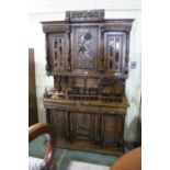 A European Carved Court Cupboard, The Upper Section Having Two Glazed Doors