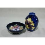 A Moorcroft Pottery Deep Blue Ground And Floral Decorated Miniature Vase And Circular Bowl, The Vase