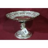 A Circular Based Silver Fruit Stand With Embossed Fruit And Vine Decoration, London 1882, Maker