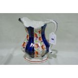 An Octagonal Gaudy Welsh Pottery Milk Jug With Scrolled Handle